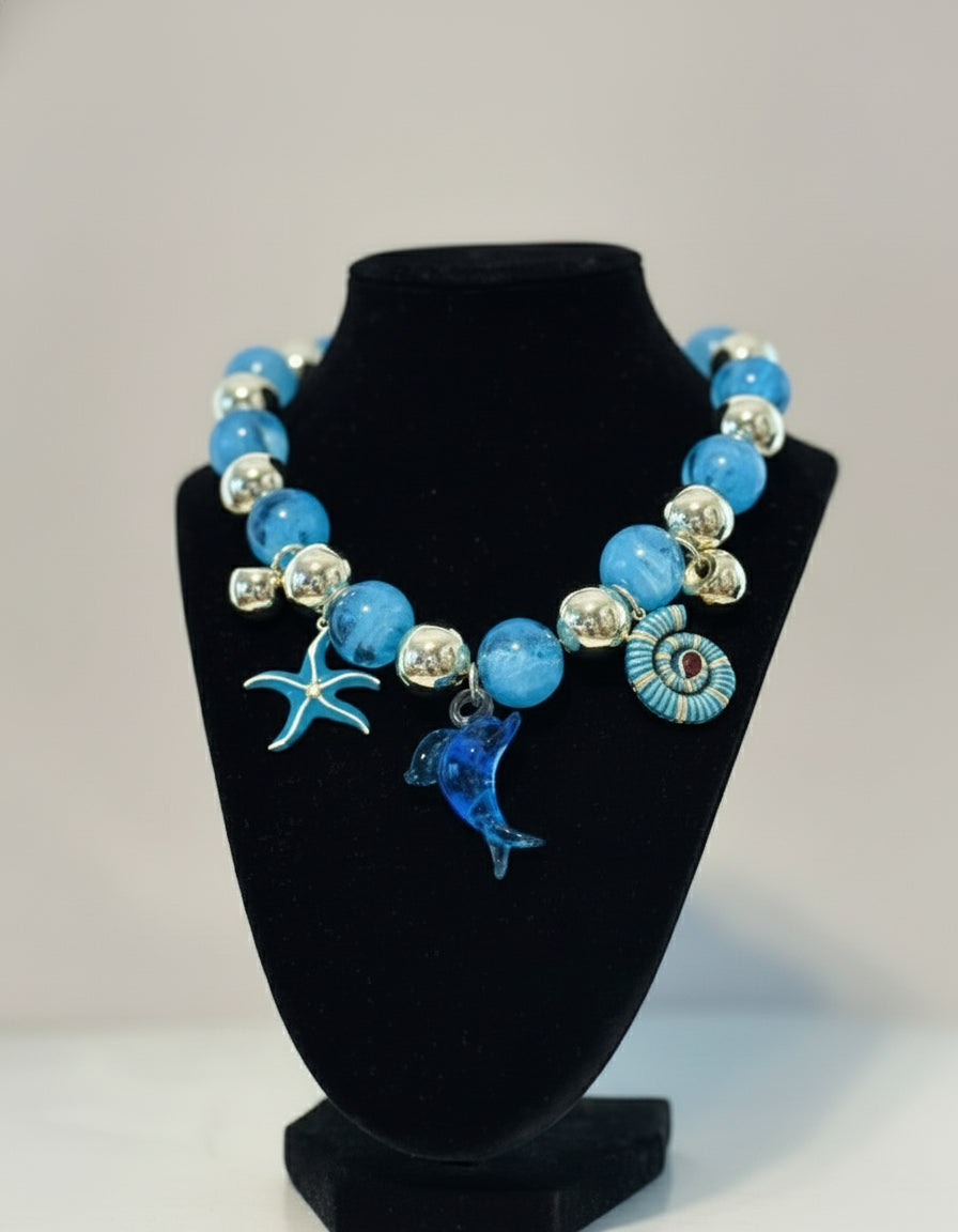 Necklace with blue beads and dolphin charms 