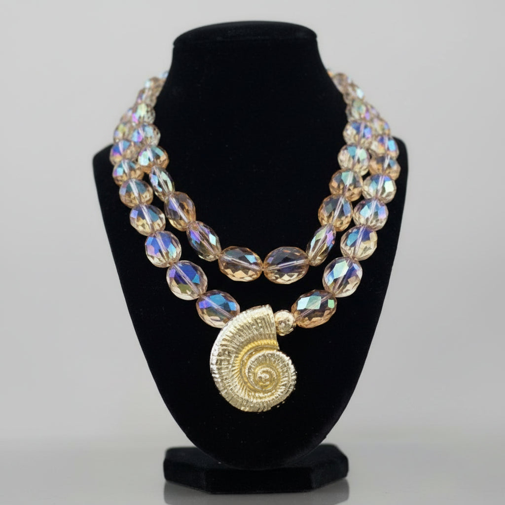 Necklace with large beads and a gold pendant.